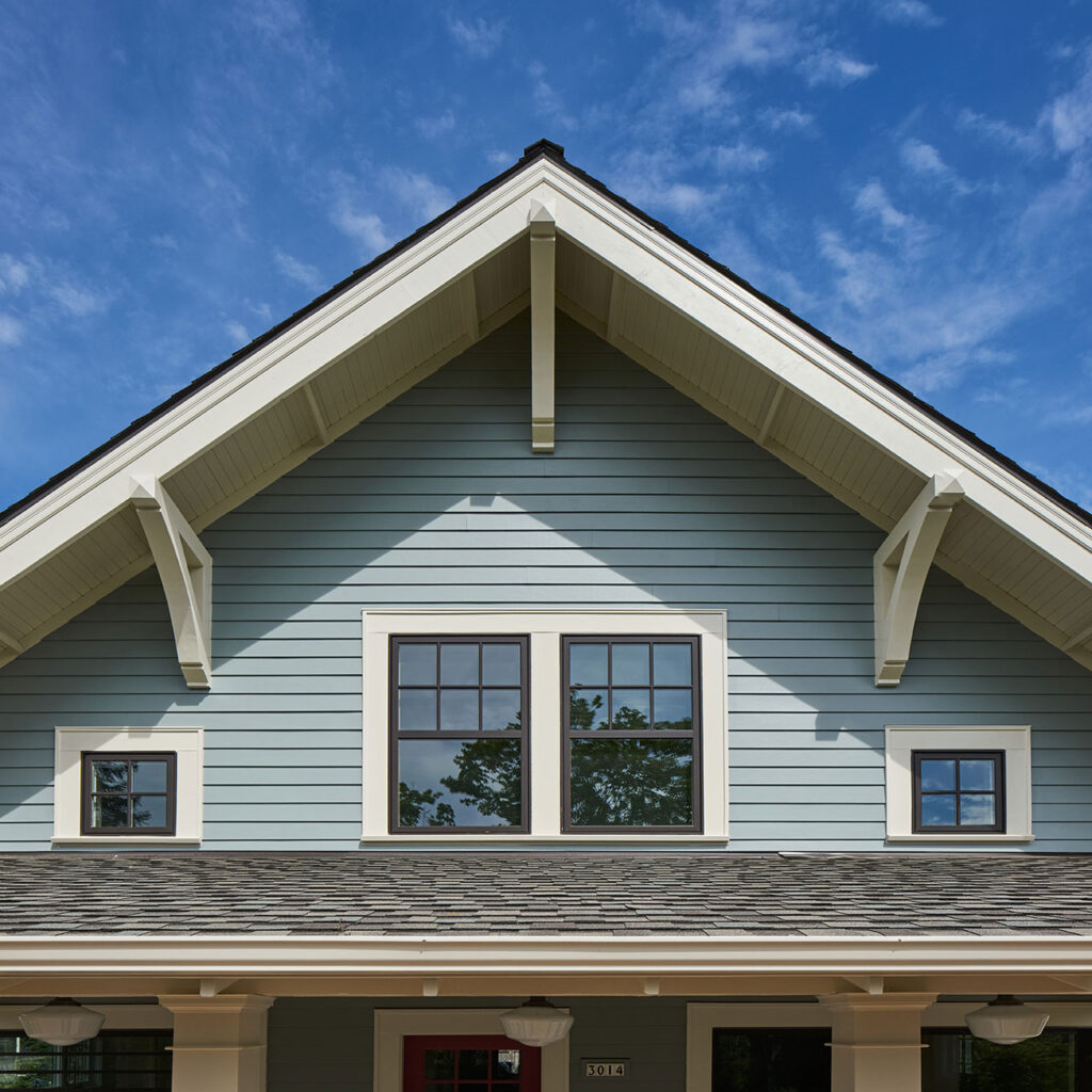 The exterior of the aging in place remodel features traditional detailing such as eave brackets, window trim with backbend, chunky columns, lap siding and tongue and groove soffits.