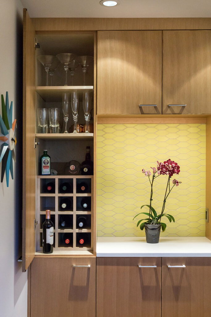 Inside one of the tall cabinets there is custom wine and barware storage at the Alameda Modern.
