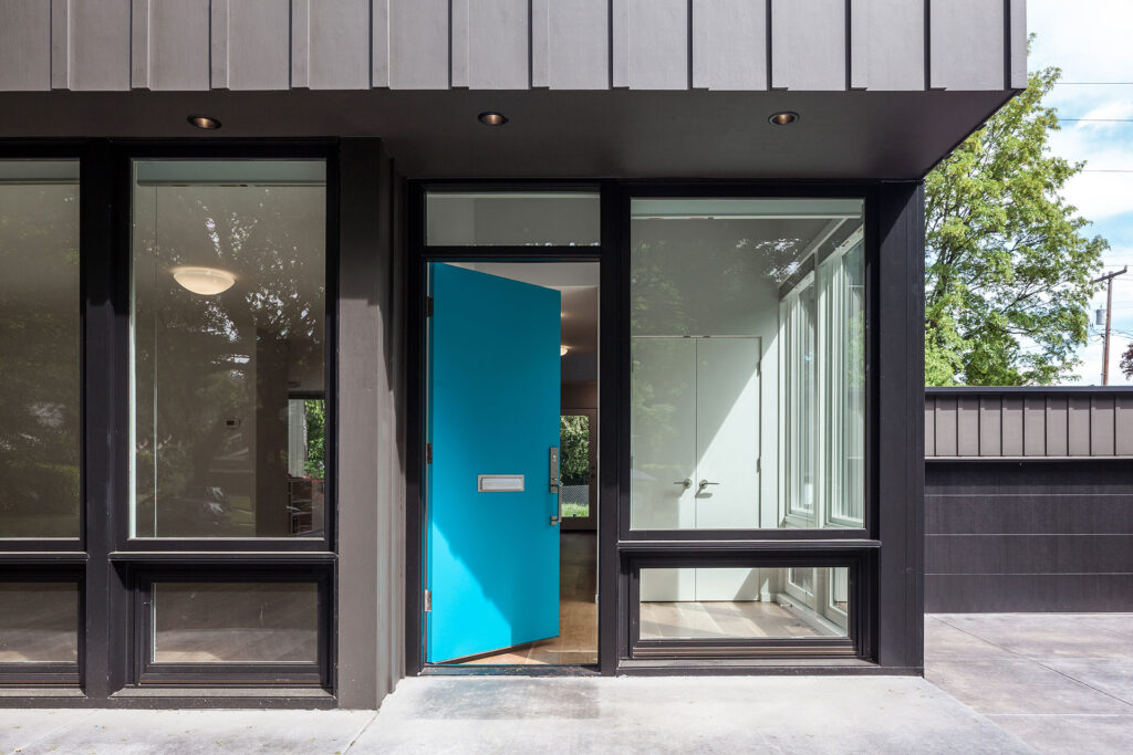A bright turquoise door welcomes you to the home designed by Christie Architecture.
