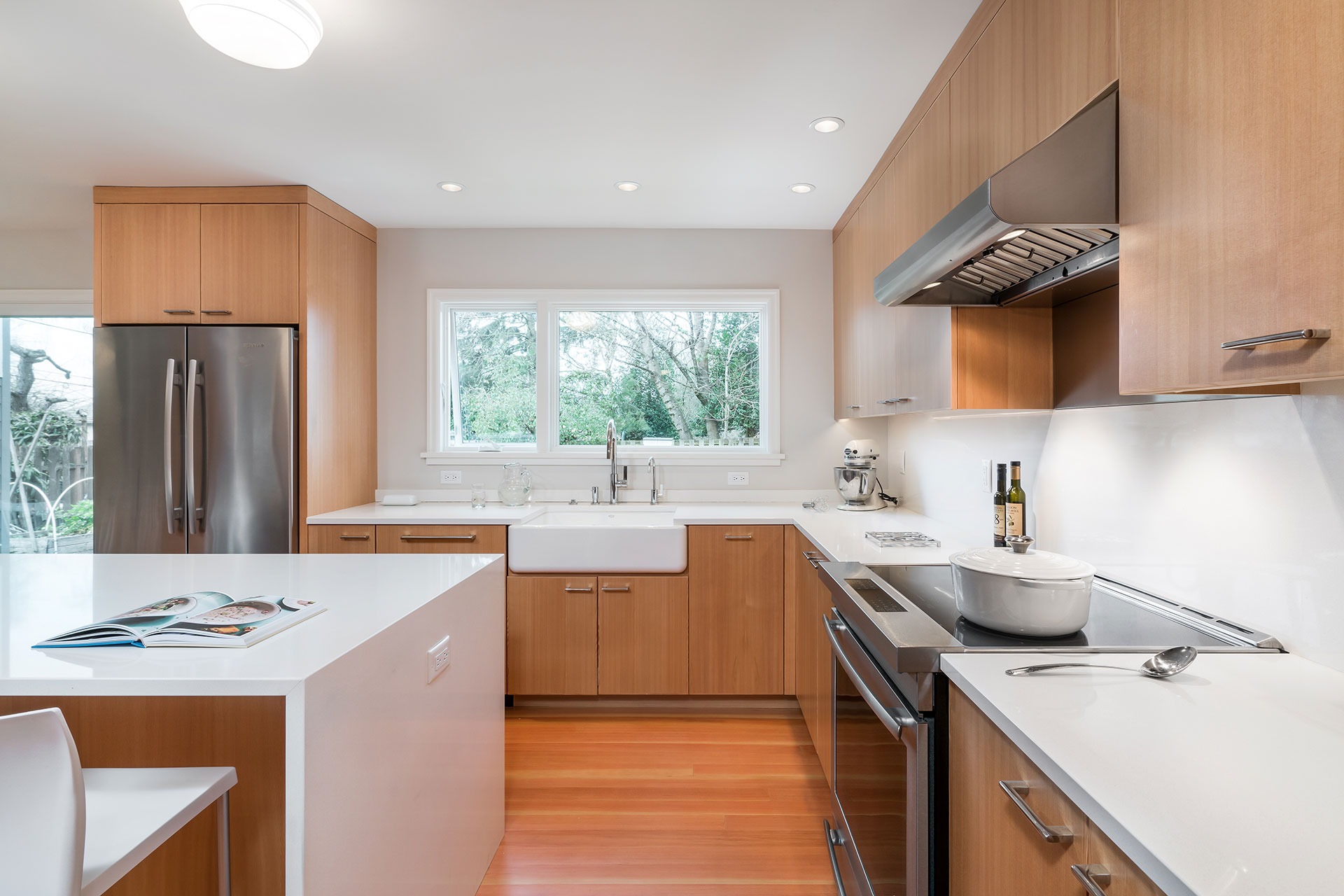 The kitchen sink and window faces a view of the back yard in this kitchen remodel.