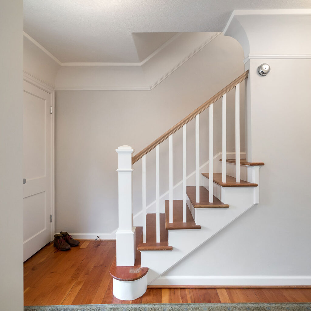 The new stair guardrail at the is traditionally detailed and fits the style of the existing house.