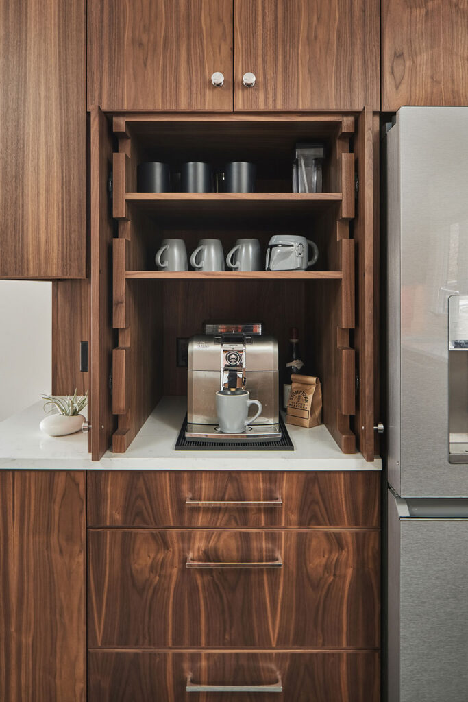 Walnut cabinetry coffee bar in open position.