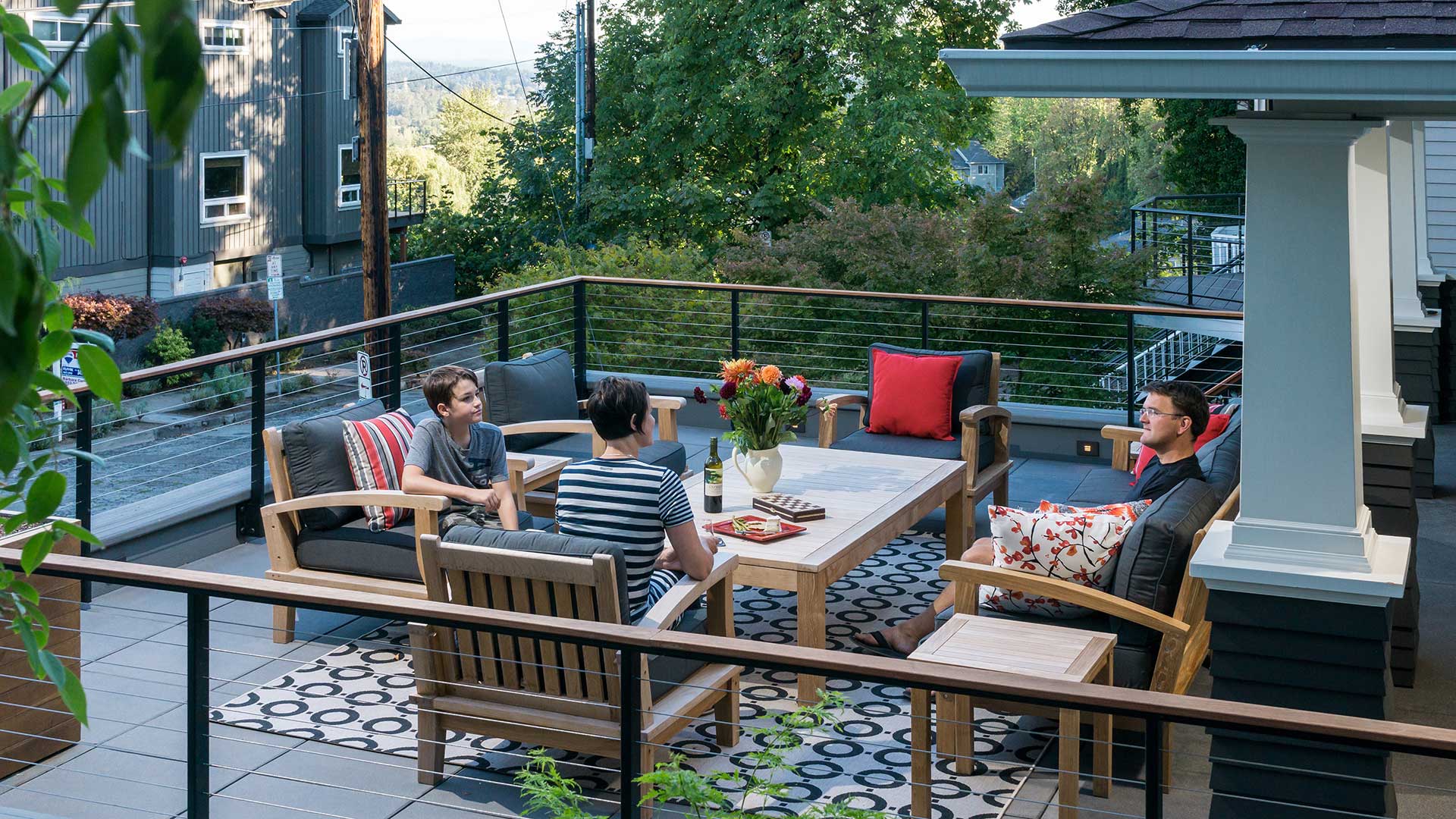 A man, woman and child enjoy the view of the river from the Family Porch.