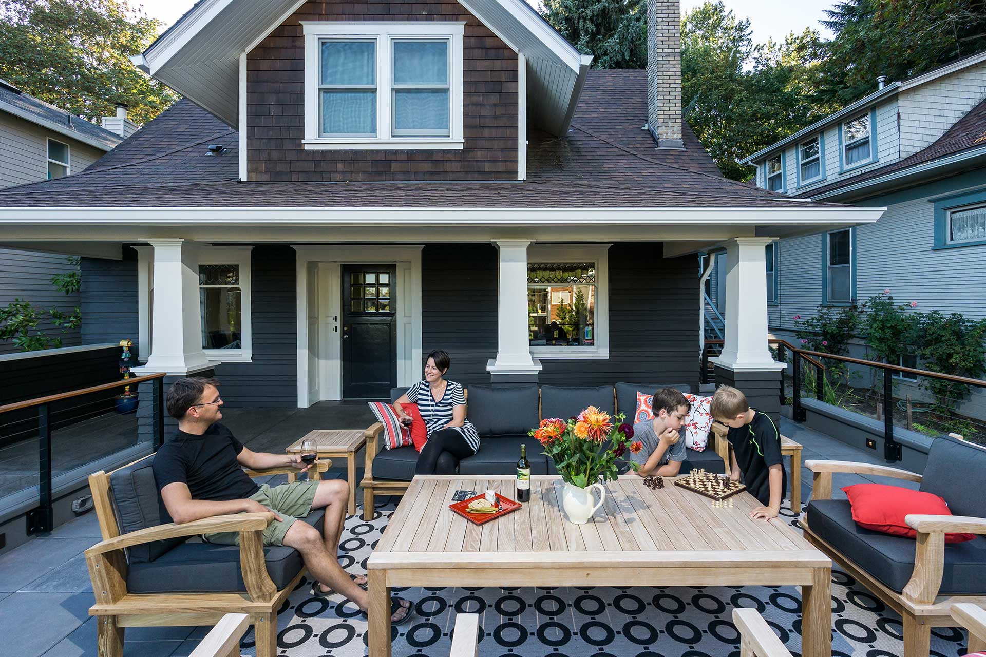 The new rooftop deck at the Family Porch sits in front of the renovated traditional Craftsman home.