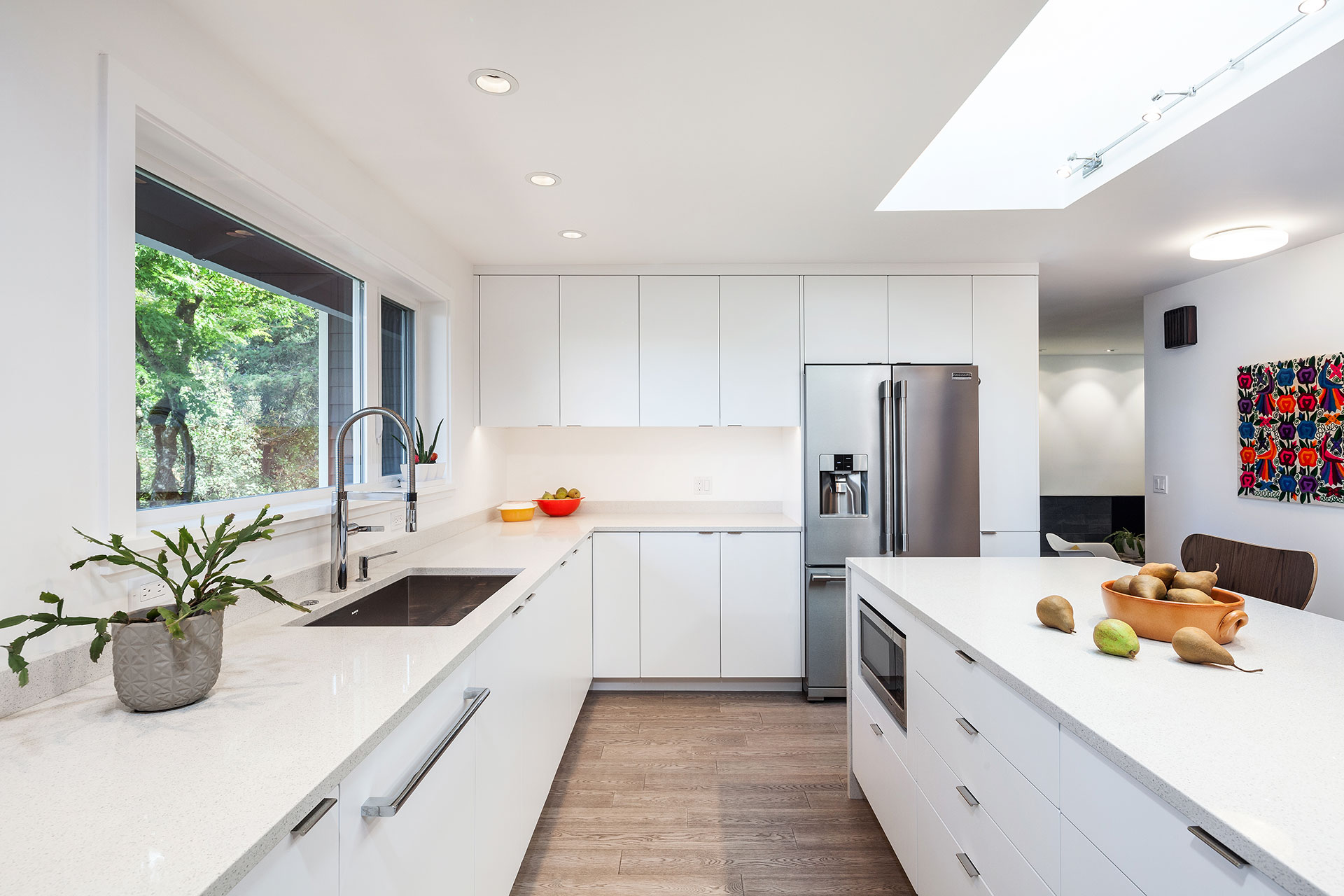 The cabinets on one side of the kitchen at the Hawkridge Modern are made from white rigid thermo-foil. The countertops are white quartz.