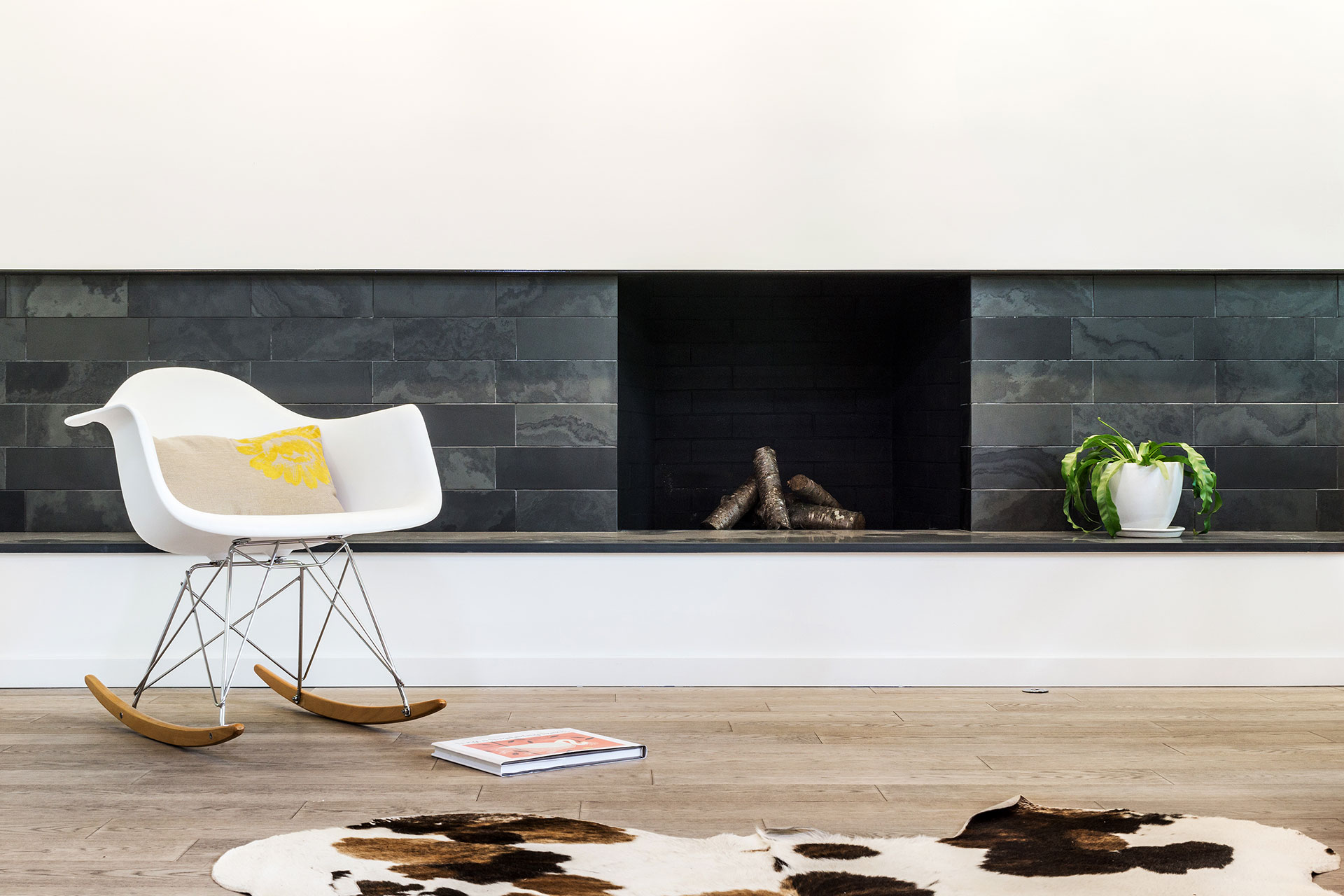 The renovated fireplace at the Hawkridge Modern is clad with Montauk Black slate.