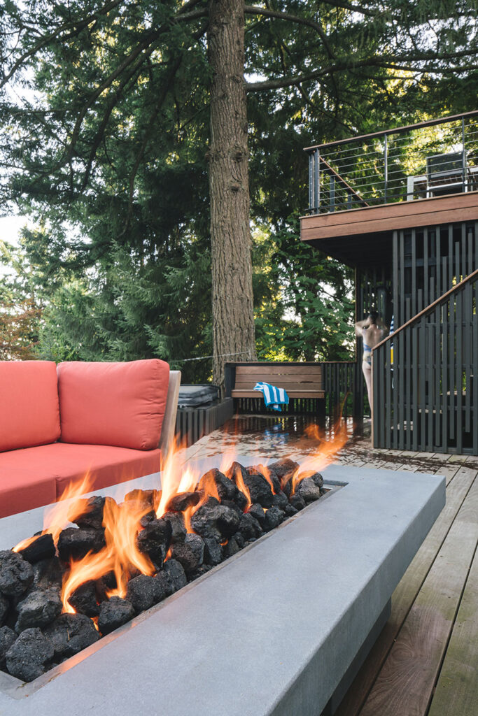 The lower deck has a custom concrete, gas-fueled fireplace.
