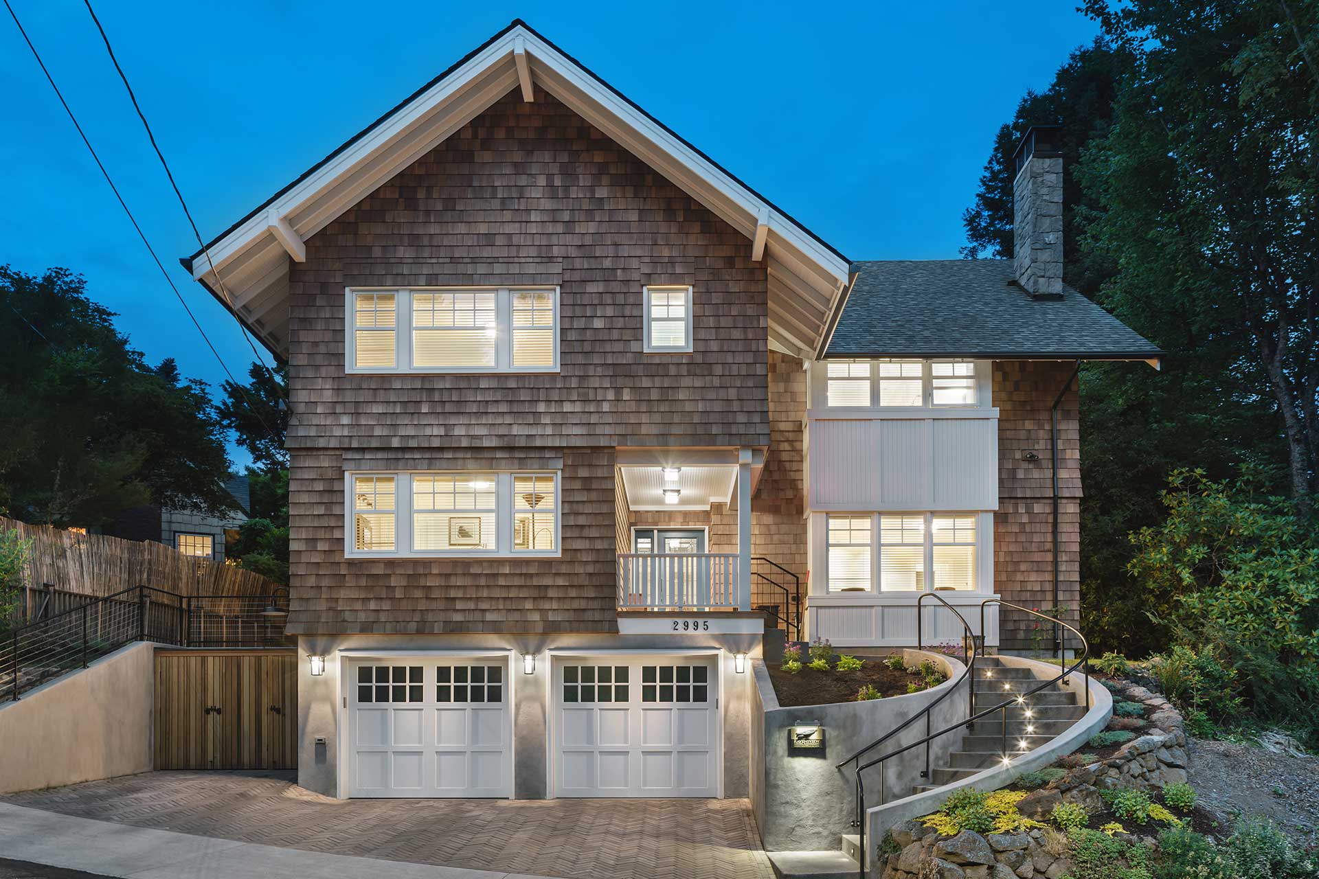 The Hillside House shown at dusk with all the interior lights turned on was designed by Christie Architecture in Portland Oregon.