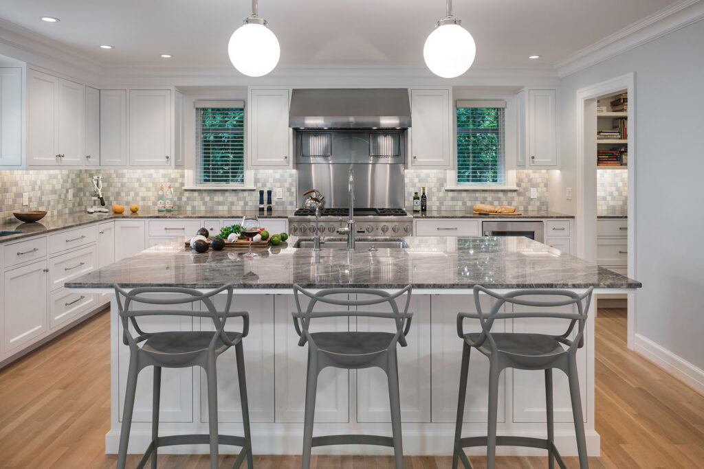 A large island creates a place for guests to hang out during meal prep in the Hillside House kitchen.