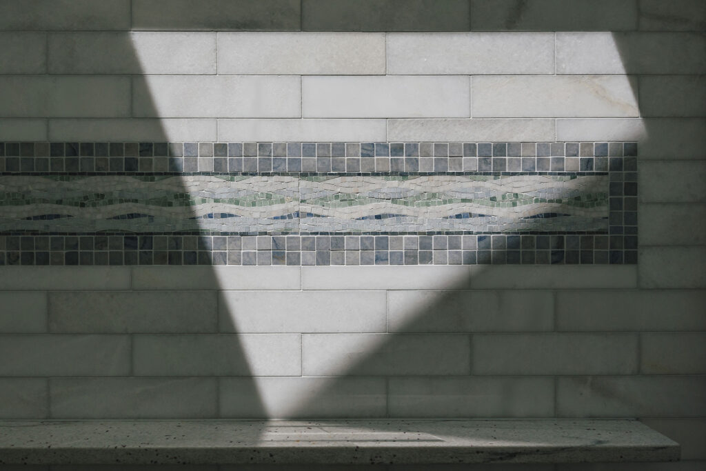 Blue and white arble mosaic tile in shower.