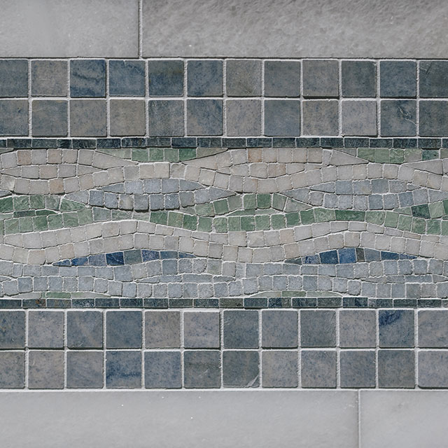 Blue and white marble mosaic tile on bathroom floor.