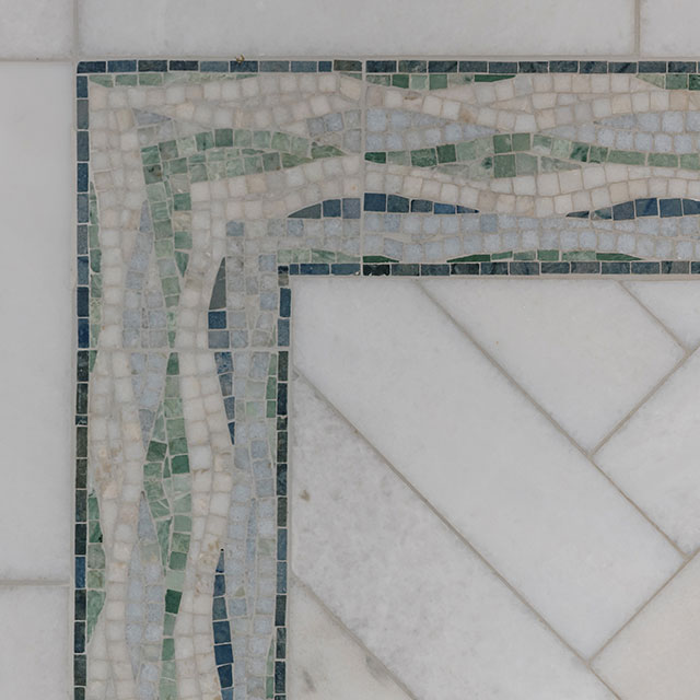 Blue and white marble mosaic tile on bathroom floor.