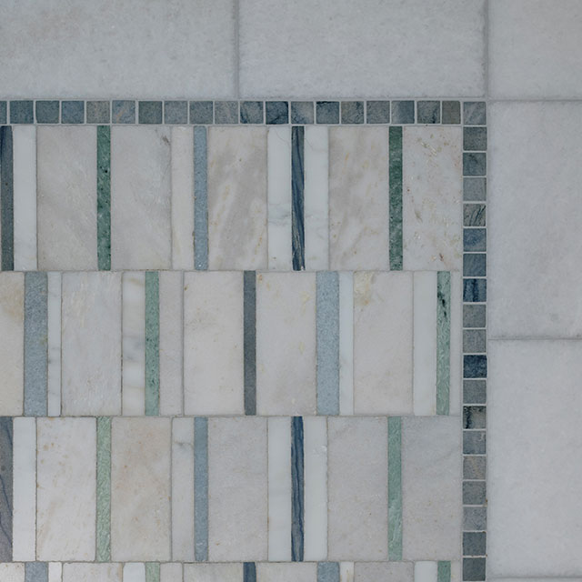 Blue and white marble mosaic tile on bathroom floor.