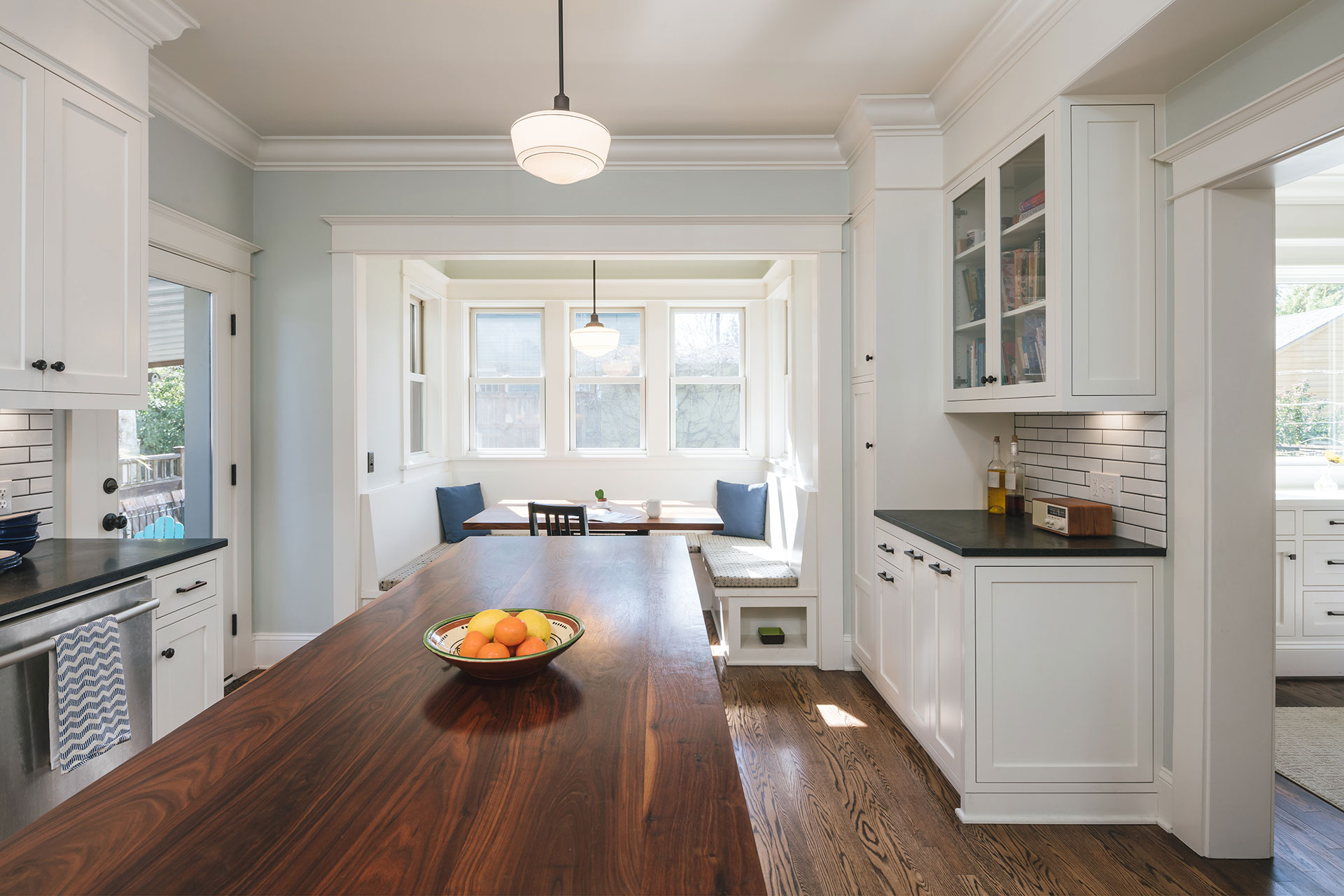 The renovated kitchen at the Laurelhurst Craftsman is bright and functional. An island sits in the middle, providing extra space for meal prep.