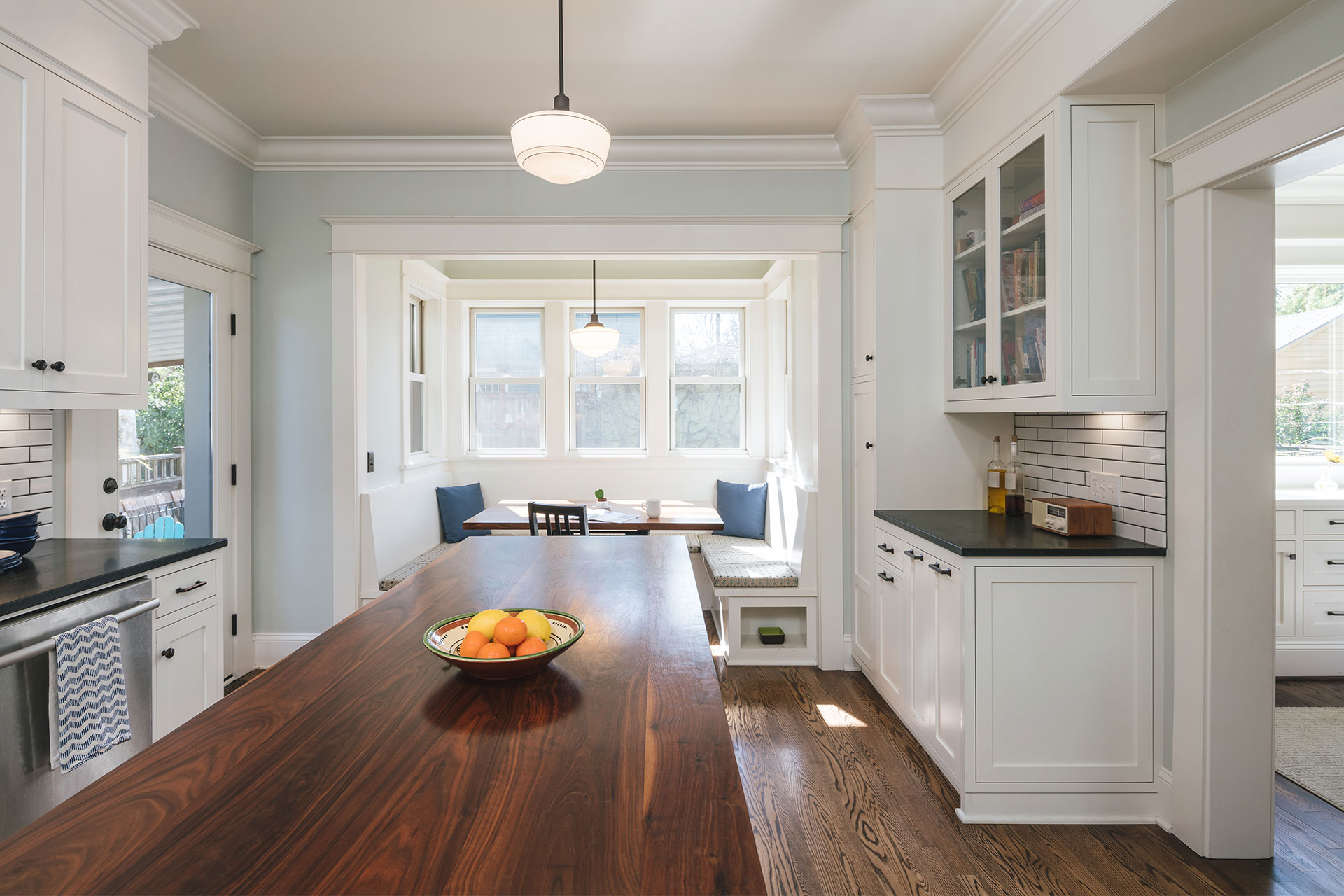 Renovated kitchen with built-in eating nook. Island with walnut butcher block counter.