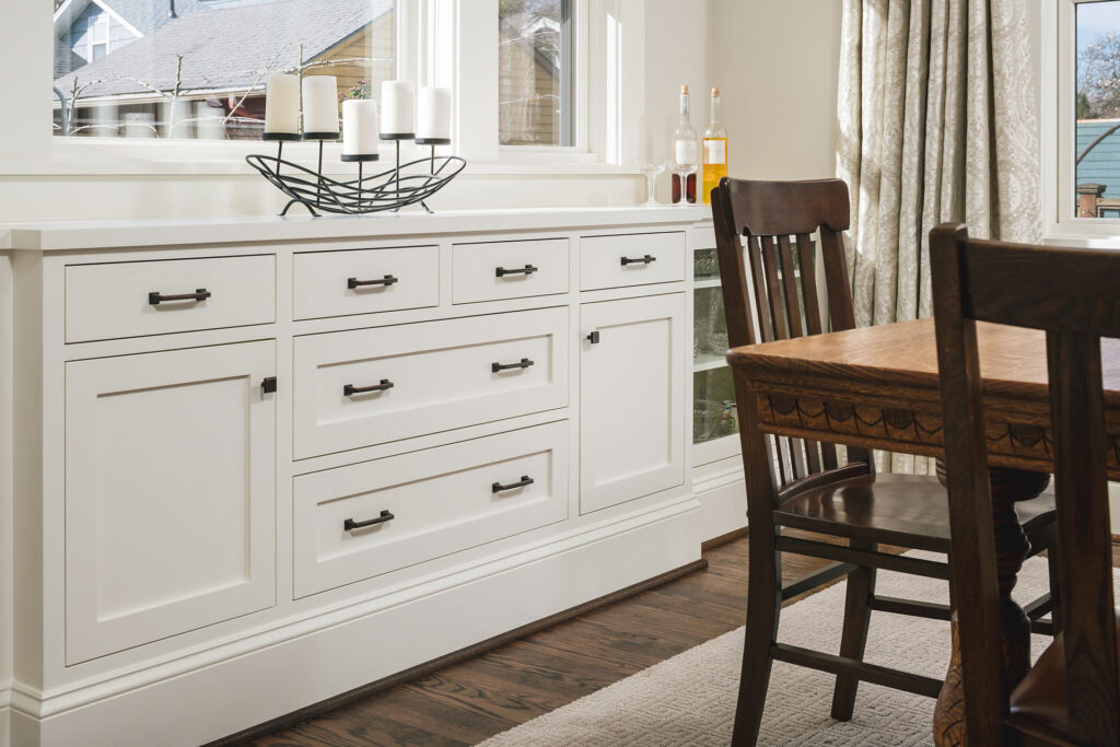 Dining room built-in buffet with white  flush inset cabinets in the whole house remodel.