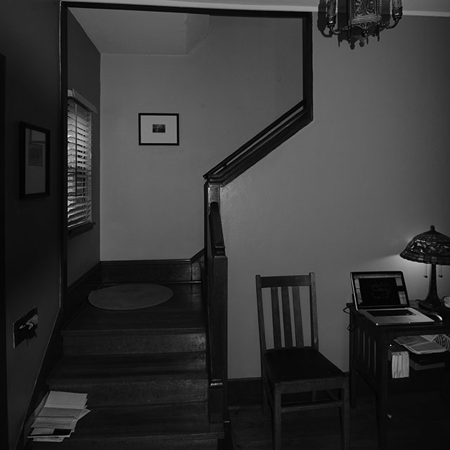 Dark, enclosed stairway before renovations.