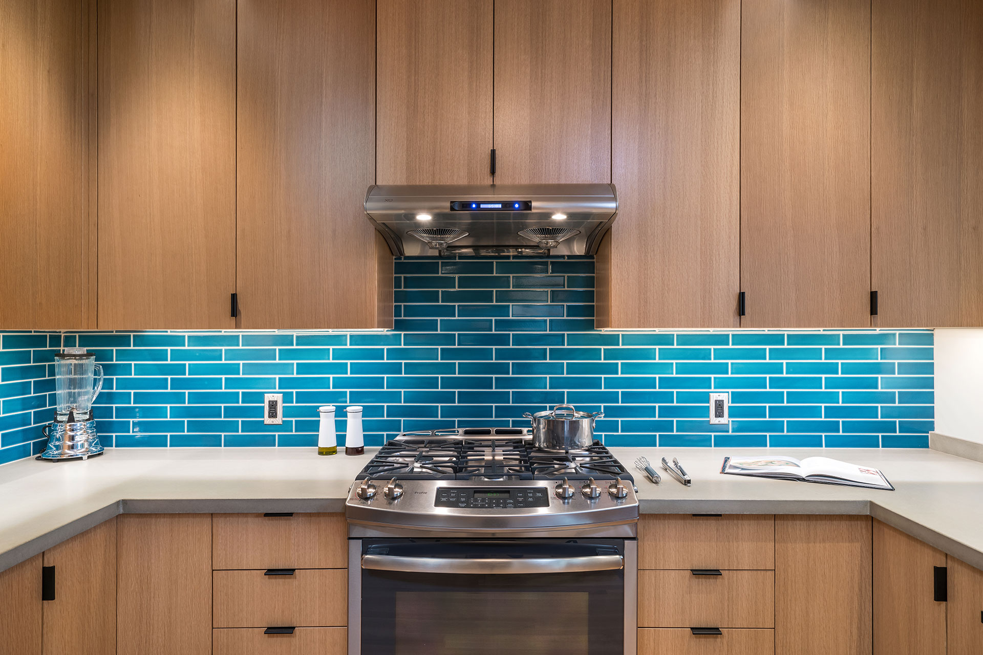 The focal point of the kitchen after the whole house renovation is the bright blue backsplash with 2" x 8" tile from Fireclay Tile.
