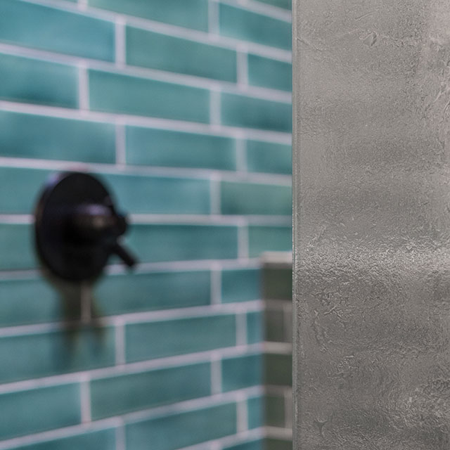 The bathroom at the Little Prescott House features ceramic wall tile from Fireclay Tile.