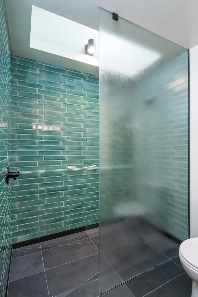 The shower at the Little Prescott House is a walk-in. It is separated from the toilet area by a full height piece of textured glass.