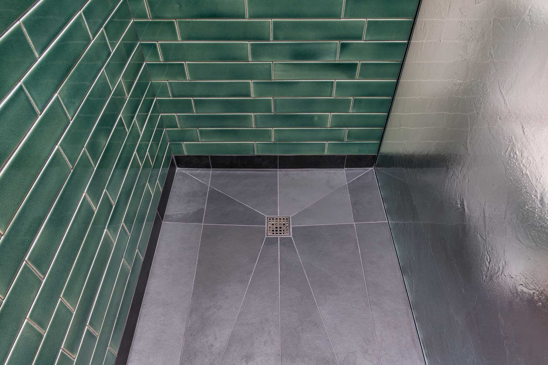The shower floor is laid with Montauk Black slate at the Little Prescott House. The shower is a walk-in.