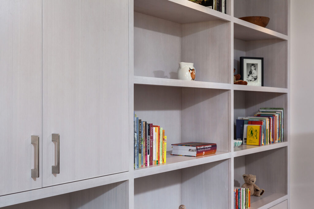 Crafted of white-stained white oak, the wall unit has space for display and concealed storage.
