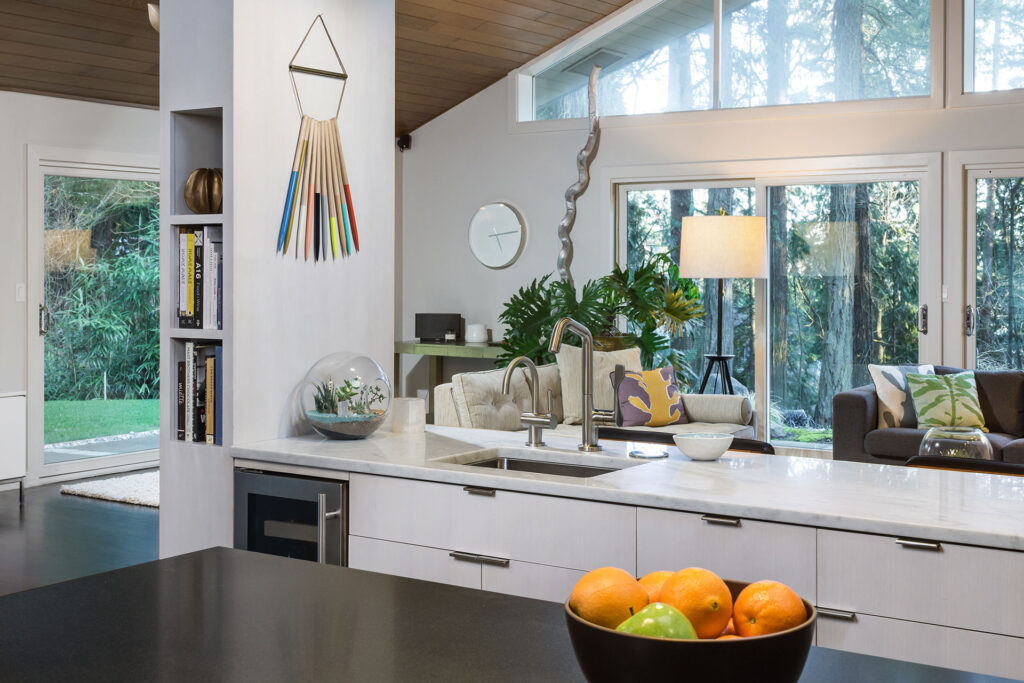The kitchen is open to the living room in this mid-century modern remodel.