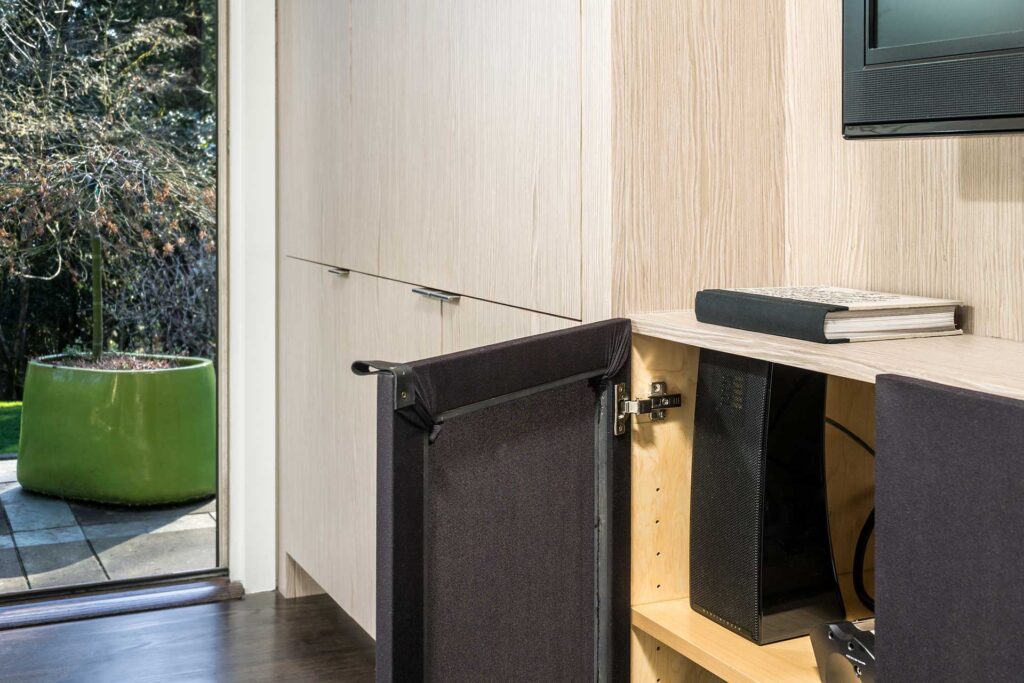 White oak cabinetry forms a custom stereo cabinet.