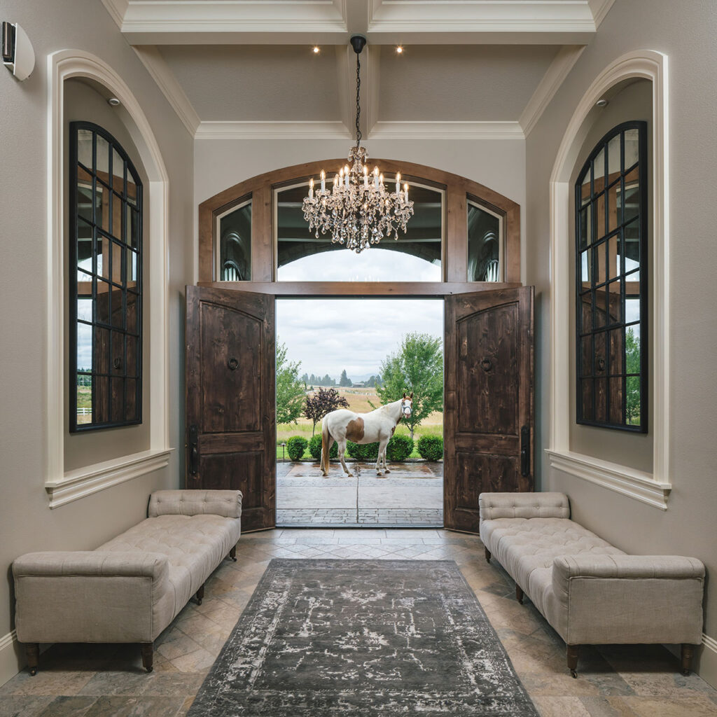 Entry hall at the whole house interior remodel with a view of a horse outside.