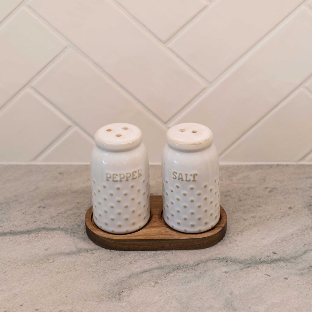 Salt and pepper shakers sit on the quartzite countertop.