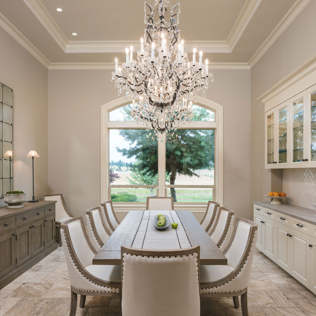 The dining room at features a new built-in buffet and glass chandelier after the whole house interior remodel.
