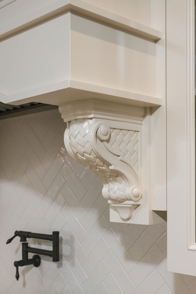Custom designed brackets support the exhaust hood over the range at Scout's House. A pot-filler offers is mounted over the range as well.
