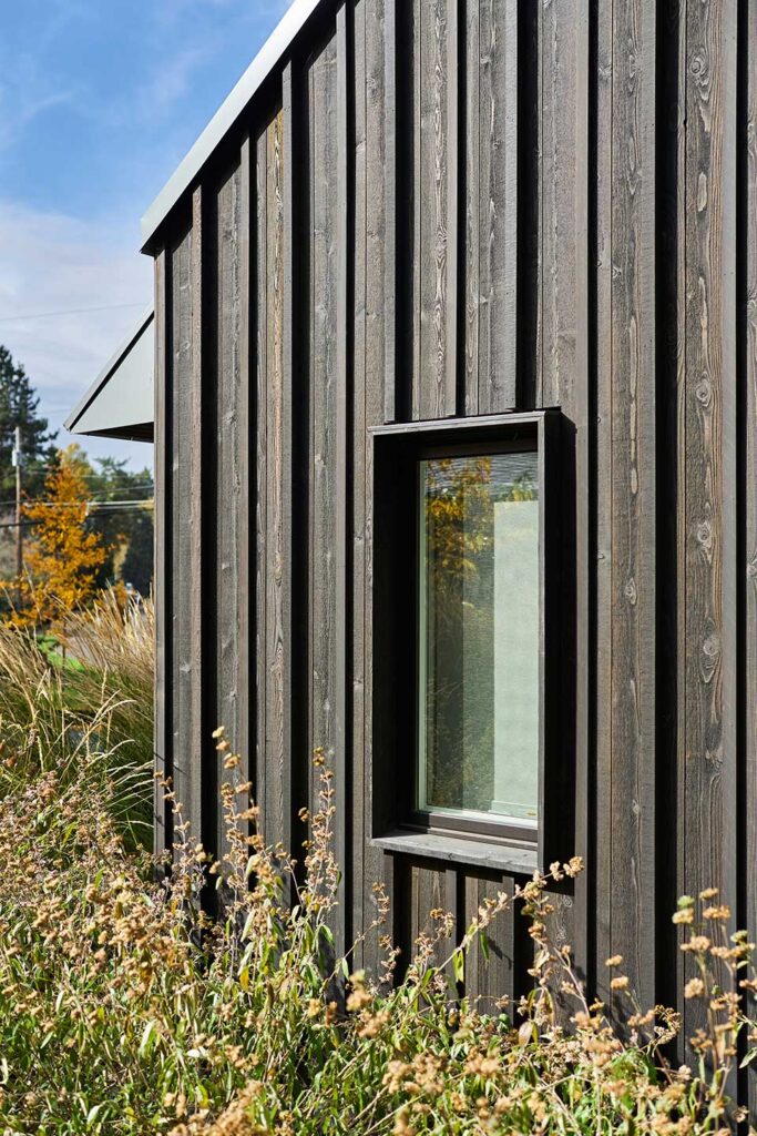 Protruding trim surrounds the windows at the Christie Architecture Studio, providing texture and shadow on the exterior of the building.