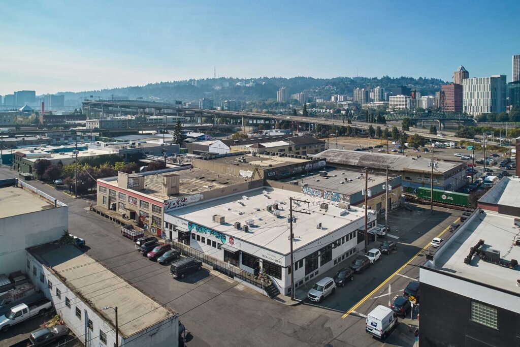 Warehouse renovation property is in the foreground with downtown Portland Oregon visible in the background.