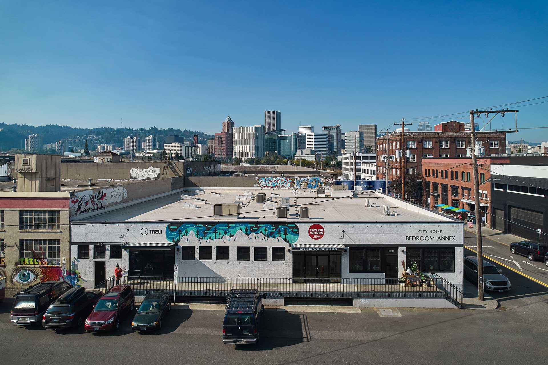 East elevation of the warehouse renovation with the downtown Portland skyline in the background.