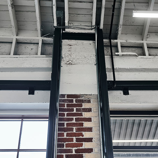 This is new steel seismic framing surrounding the old brick columns and windows at the Taylor Building.