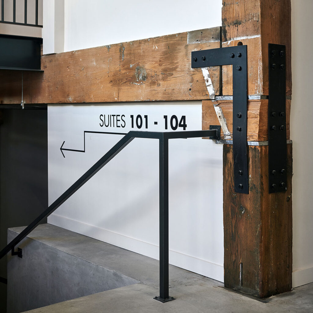 Custom steel details at the stair hand and guardrails in the warehouse renovation.