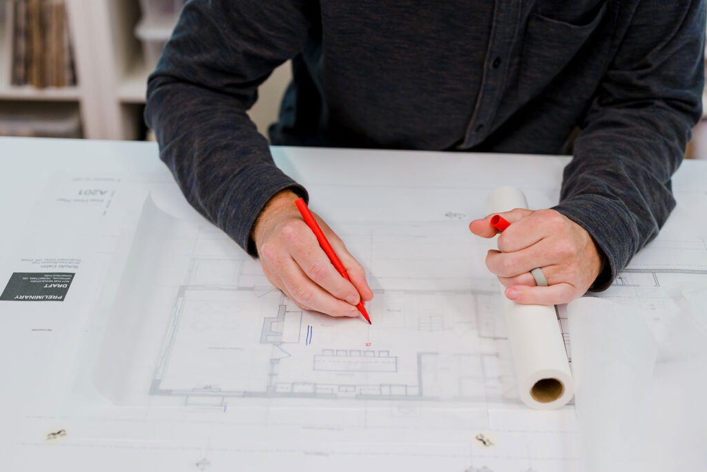 Adam Christie works on a drawing of a kitchen.