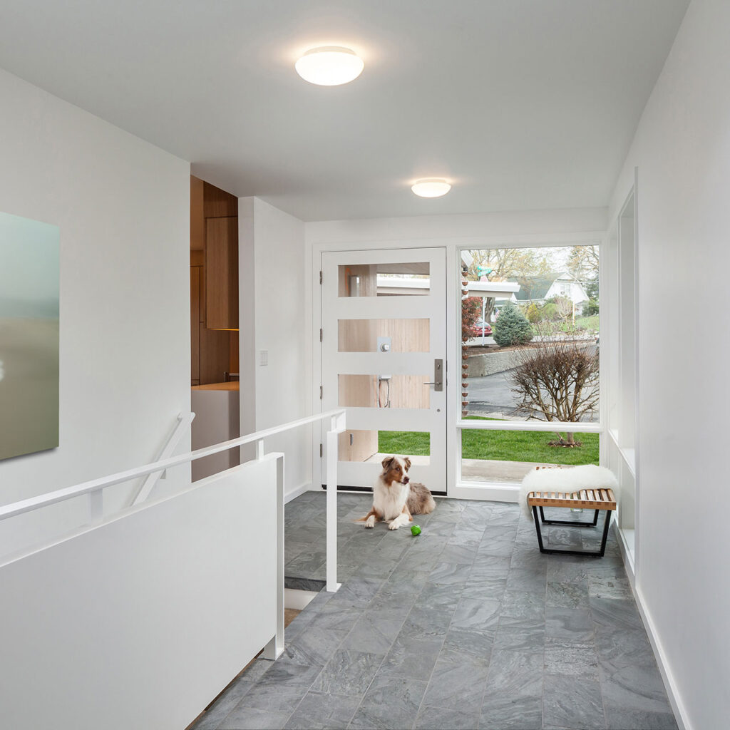 After the mid-century home remodel, the entry hall is bright and welcoming.
