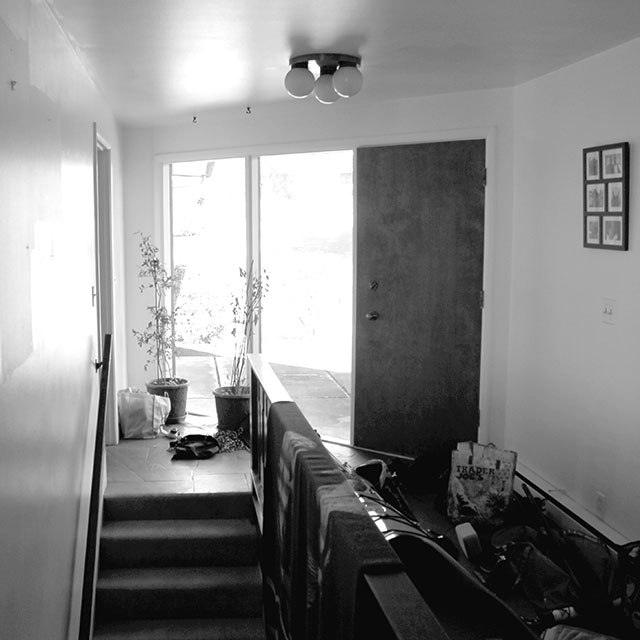 Before the mid-century home remodel, the existing entry hall was dark and cluttered with outdoor gear.