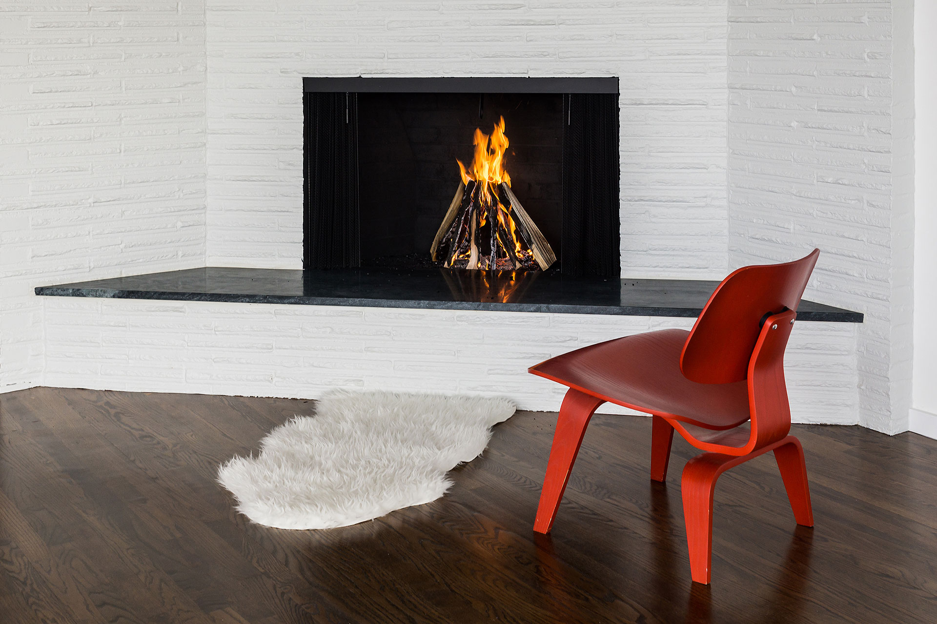 The living room has a wood burning fireplace with a new gray limestone hearth.