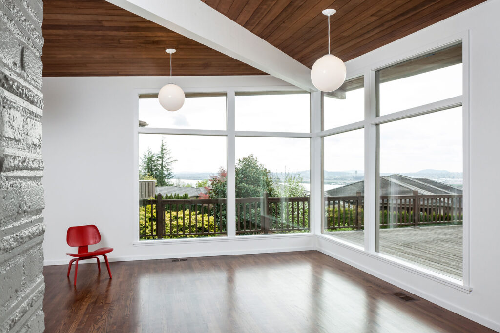 The living room has a view of the river and Portland International Airport.