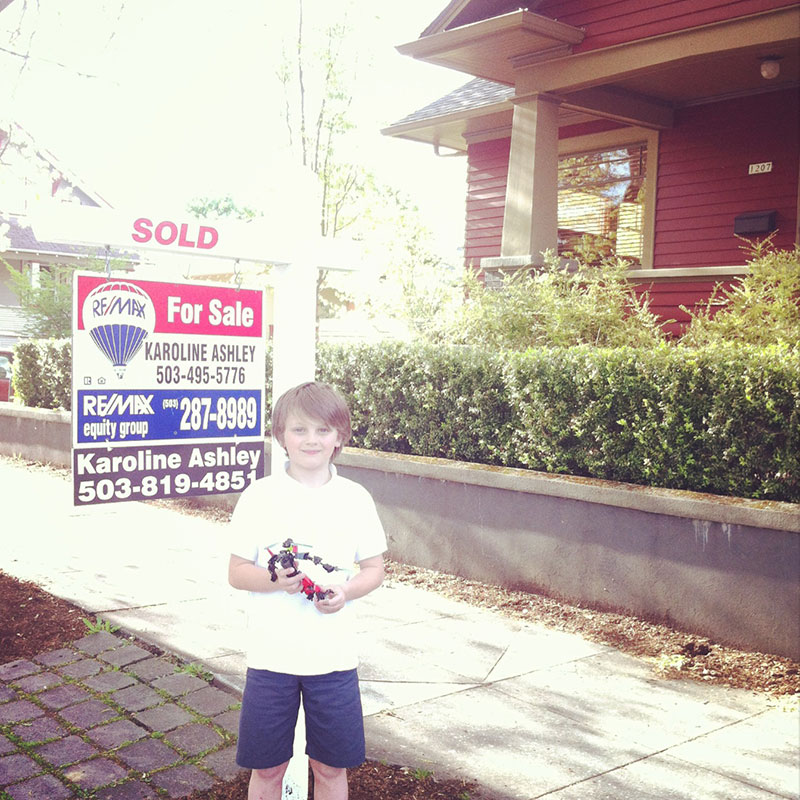 A little boy stands outside his house which was just sold by Karoline Ashley from ReMax Equity Group.