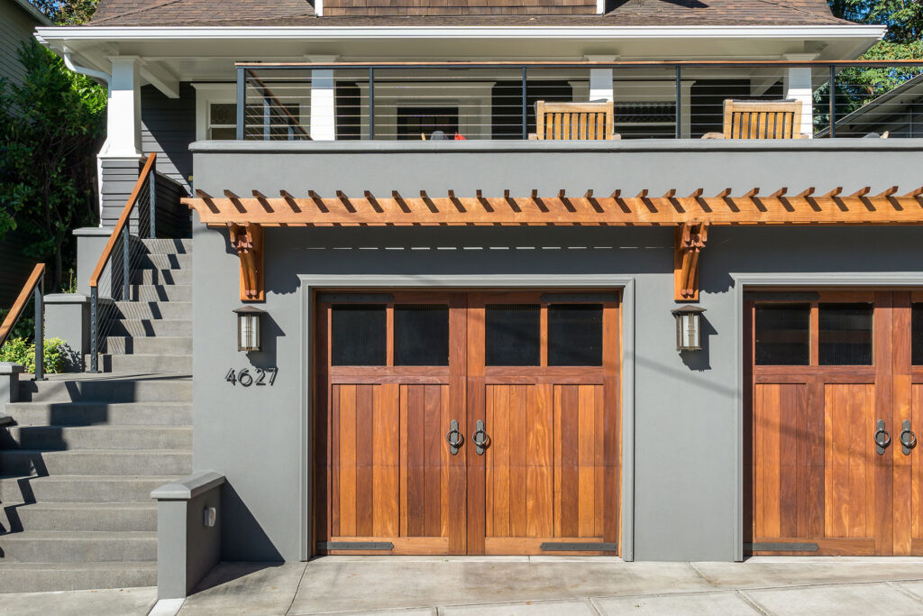 The new garage has custom Ipe garage doors and an Ipe trellis, which add interest and texture to sidewalk level.