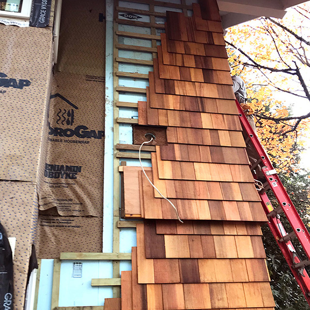 A rain screen being installed on a house.