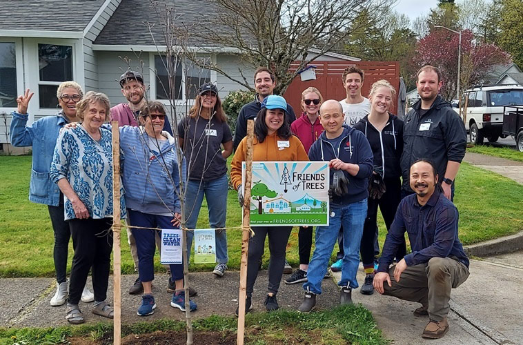 This is a group of volunteers with Friends of Trees who have just planted a new tree in a parking strip.