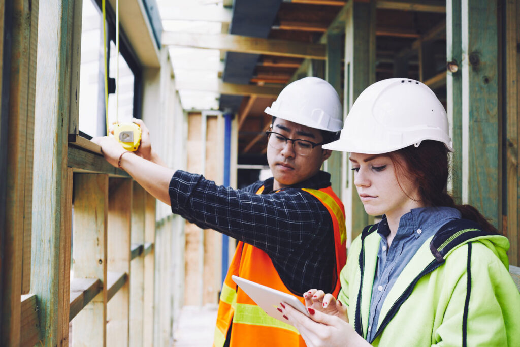 A FIR inspector and general contractor review drawings on site.