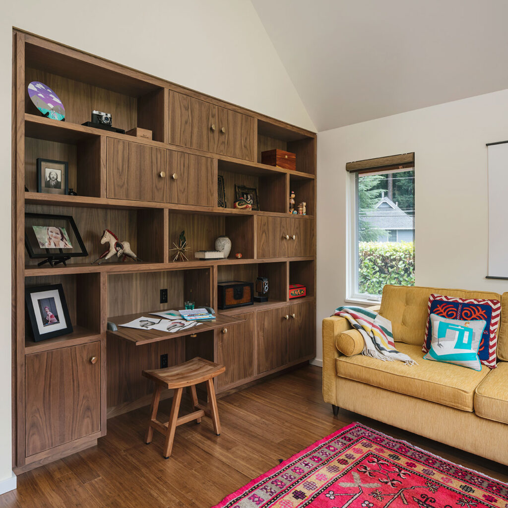 The Zen Room at features a full wall of custom cabinetry storage space, display space, and a fold-down desk.