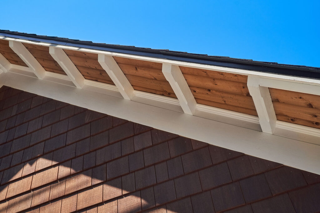 The eaves are stained cedar with custom painted rafter tails.