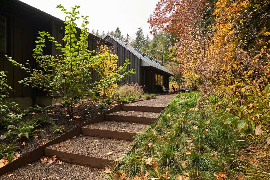 Steel stairs with gravel infill lead to a patio behind the Studio at Christie Architecture.